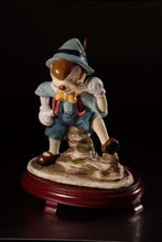 Cargar imagen en el visor de la galería, Figura de Pinocho de cerámica sobre centros de mesa con base de madera de cerezo #9D6734
